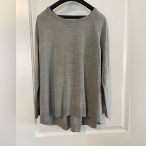 Grey sweater with a fold in the back.